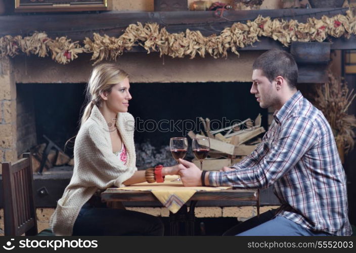 happy Young romantic couple and relaxing sofa in front of fireplace at winter season in home