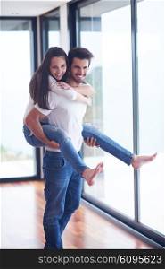 happy young romantic couple have fun relax smile at modern home livingroom interior