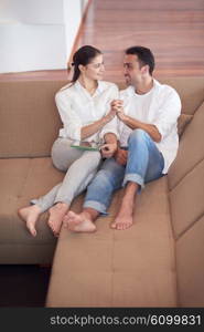 happy young romantic couple have fun relax smile at modern home livingroom interior
