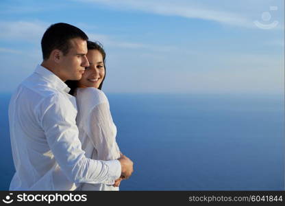 happy young romantic couple have fun relax smile at modern home outdoor terace balcony