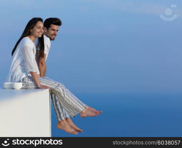 happy young romantic couple have fun relax smile at modern home outdoor terace balcony terace