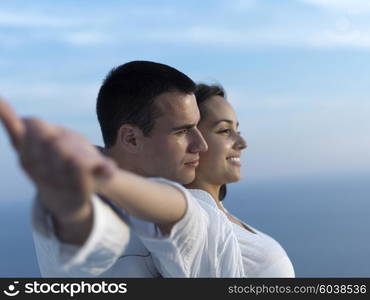 happy young romantic couple have fun relax smile at modern home outdoor terace balcony terace