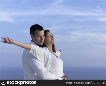 happy young romantic couple have fun relax smile at modern home outdoor terace balcony terace