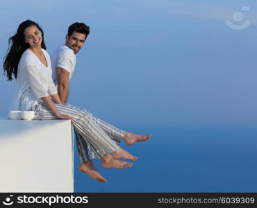 happy young romantic couple have fun relax smile at modern home outdoor terace balcony terace