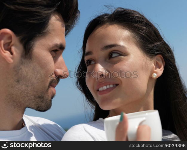 happy young romantic couple have fun relax smile at modern home outdoor terace balcony terace