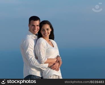 happy young romantic couple have fun relax smile at modern home outdoor terace balcony terace