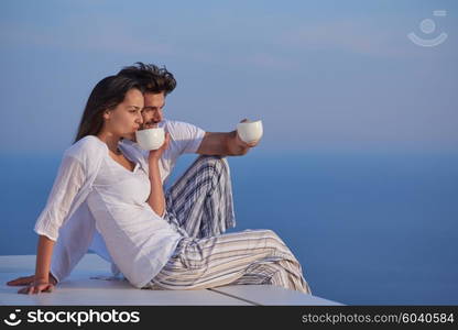 happy young romantic couple have fun relax smile at modern home outdoor terace balcony terace