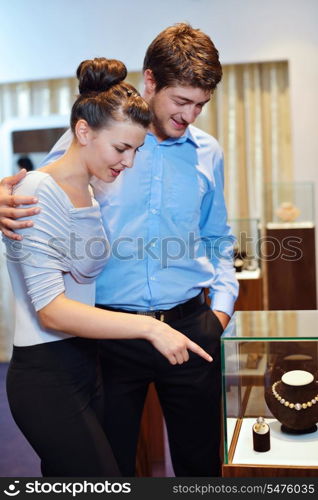 happy young romantic couple in love buy jewelry ring in luxury store