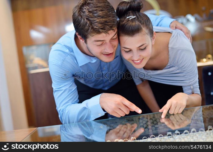 happy young romantic couple in love buy jewelry ring in luxury store