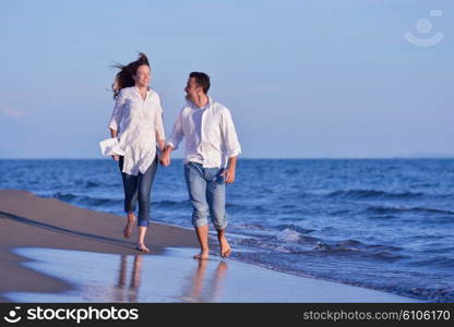 happy young romantic couple in love have fun on beautiful beach at beautiful summer day