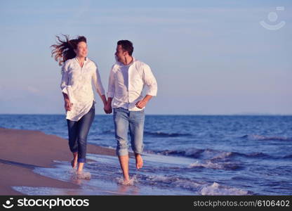 happy young romantic couple in love have fun on beautiful beach at beautiful summer day