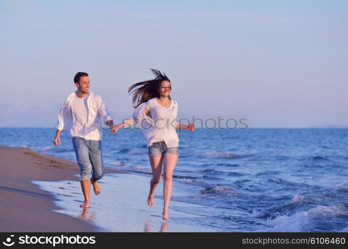 happy young romantic couple in love have fun on beautiful beach at beautiful summer day