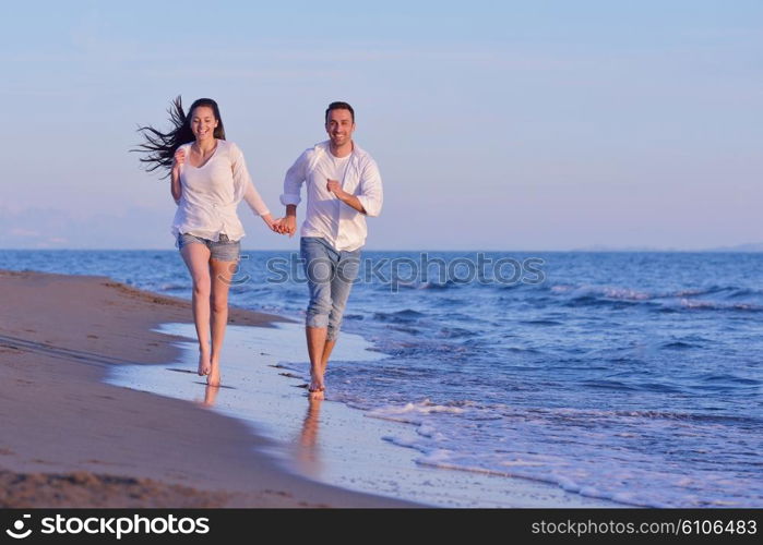 happy young romantic couple in love have fun on beautiful beach at beautiful summer day