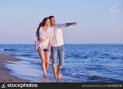 happy young romantic couple in love have fun on beautiful beach at beautiful summer day