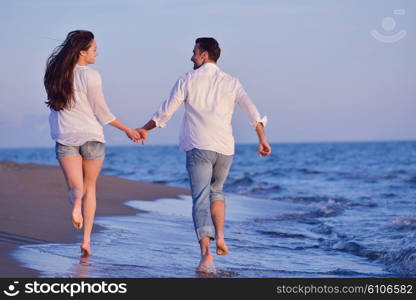 happy young romantic couple in love have fun on beautiful beach at beautiful summer day