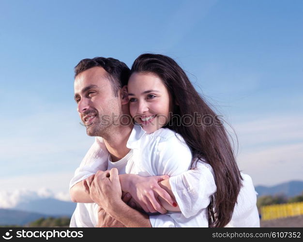 happy young romantic couple in love have fun on beautiful beach at beautiful summer day