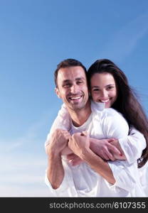 happy young romantic couple in love have fun on beautiful beach at beautiful summer day