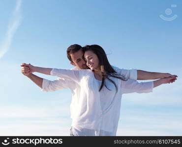 happy young romantic couple in love have fun on beautiful beach at beautiful summer day