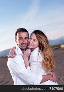 happy young romantic couple in love have fun on beautiful beach at beautiful summer day