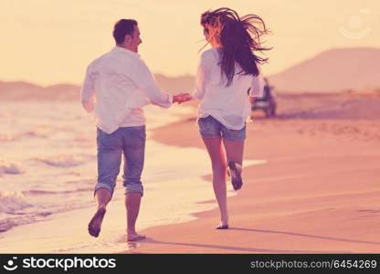 happy young romantic couple in love have fun on beautiful beach at beautiful summer day