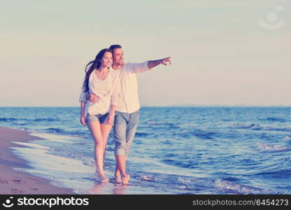 happy young romantic couple in love have fun on beautiful beach at beautiful summer day