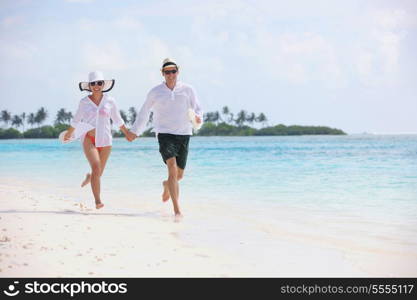 happy young romantic couple in love have fun running and relaxing on beautiful beach