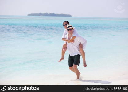 happy young romantic couple in love have fun running and relaxing on beautiful beach