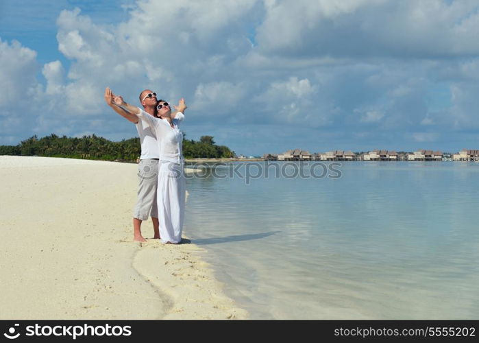 happy young romantic couple in love have fun running and relaxing on beautiful beach