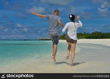 happy young romantic couple in love have fun running and relaxing on beautiful beach