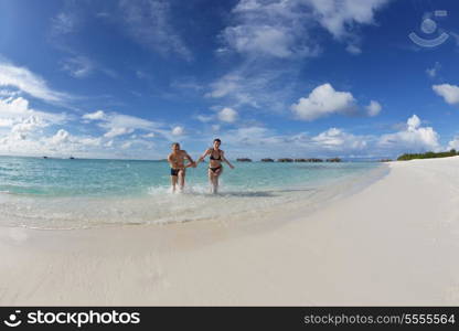 happy young romantic couple in love have fun running and relaxing on beautiful beach