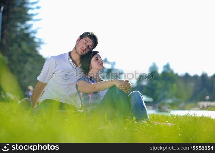 happy young romantic couple in love having a picnic outdoor on a summer day