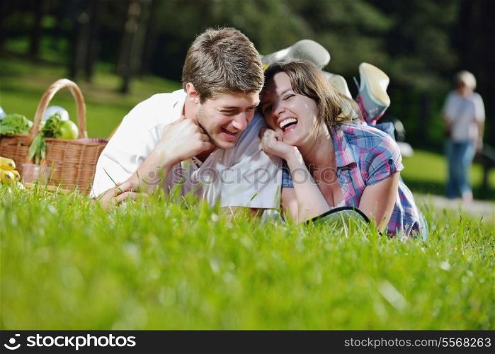 happy young romantic couple in love having a picnic outdoor on a summer day