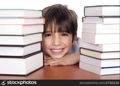 Happy young school boy surrounded by books on white background