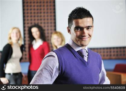 happy young student boy posing at university school classroom