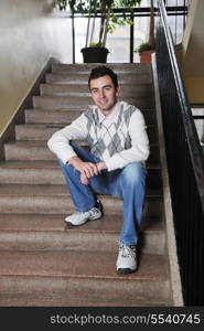 happy young student boy posing at university school classroom