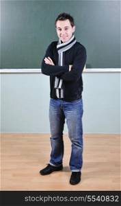 happy young student boy posing at university school classroom