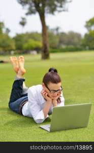 happy young student woman with laptop in city park study