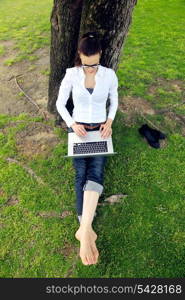 happy young student woman with laptop in city park study