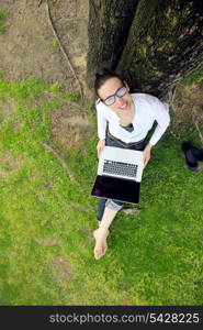 happy young student woman with laptop in city park study