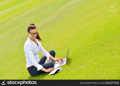 happy young student woman with laptop in city park study