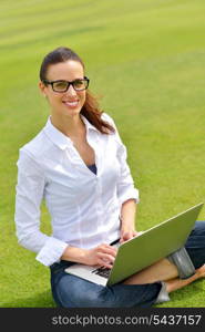 happy young student woman with laptop in city park study