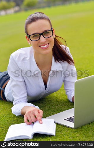 happy young student woman with laptop in city park study