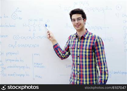 happy young teenage boy portrait in school on chemistry classes and library