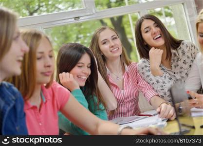 happy young teens group in school on chemisty lessons and library education