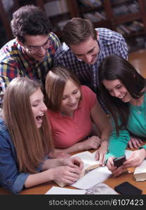 happy young teens group in school on chemisty lessons and library education