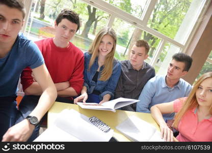 happy young teens group in school on chemisty lessons and library education