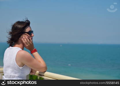 happy young tourist woman have fun while traveling araund city with blue sky and sea in background