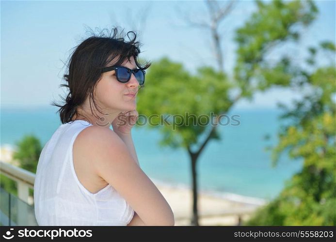 happy young tourist woman have fun while traveling araund city with blue sky and sea in background