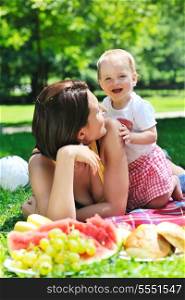 happy young woman and baby have fun while playing in beautiful bright park at summer season