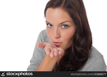 Happy young woman blowing a kiss on white background